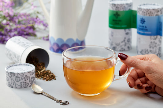 Loose leaf Calm and Claritea steeping in glass cup showing herbal infusion for stress relief
