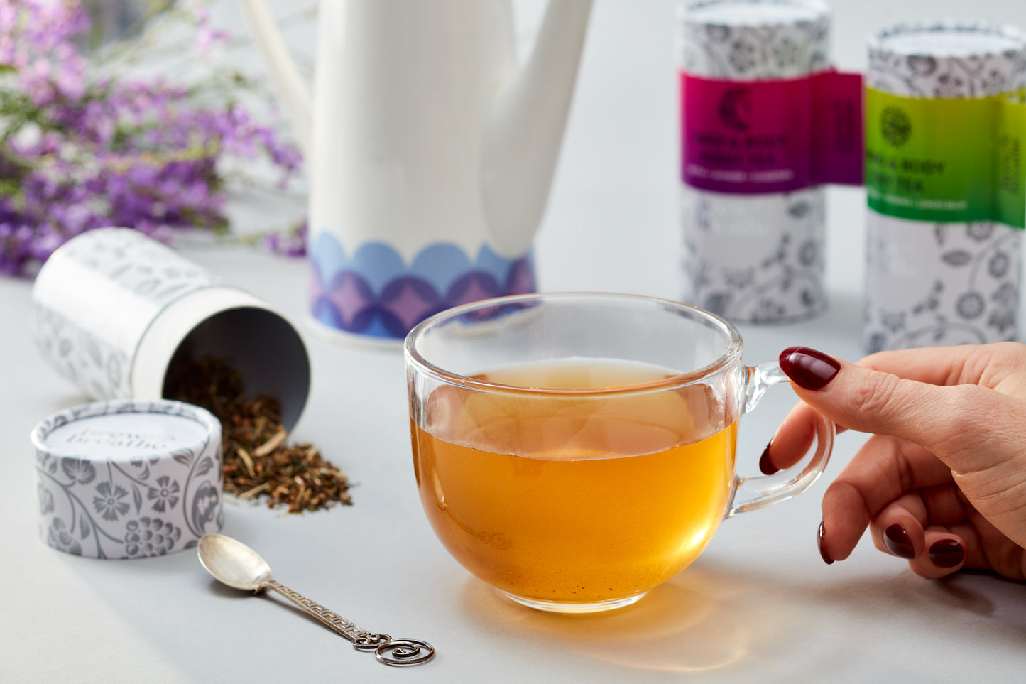 Loose leaf Mind and Body Day Tea steeping in ceramic mug showing amber herbal infusion
